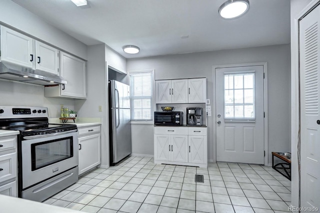 19804 Summerset Ln, Parker, CO 80138 - kitchen featuring stainless steel appliances, under cabinet range hood, white cabinets, and light tile patterned floors