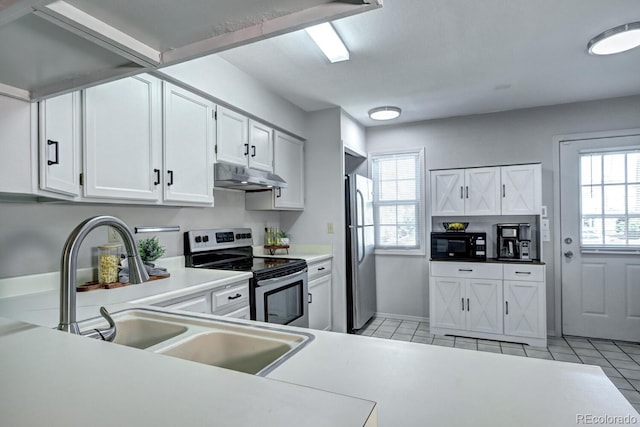 19804 Summerset Ln, Parker, CO 80138 - kitchen featuring appliances with stainless steel finishes, under cabinet range hood, white cabinetry, light countertops, and light tile patterned floors