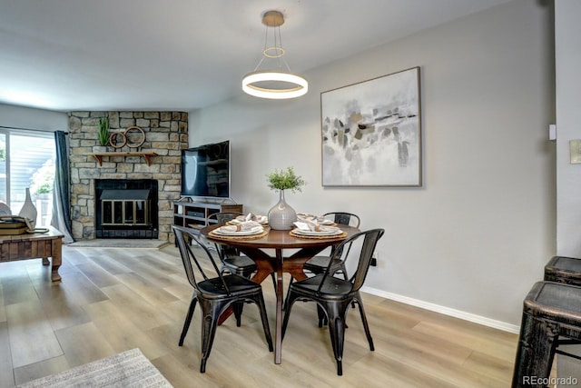 19804 Summerset Ln, Parker, CO 80138 - dining space with light wood-type flooring and a fireplace