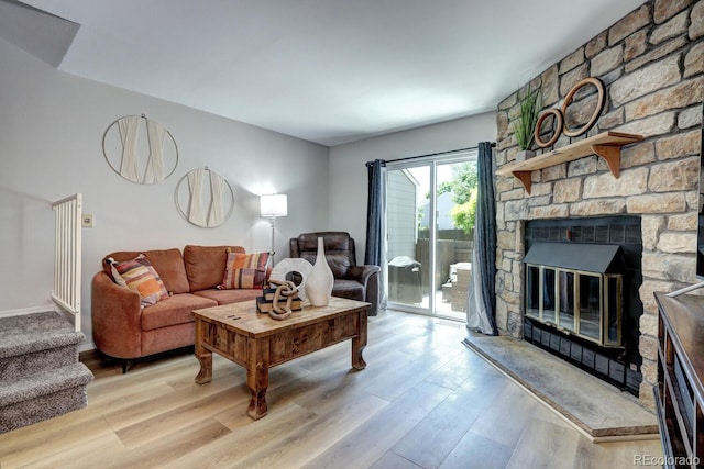 19804 Summerset Ln, Parker, CO 80138 - living area featuring light wood-style flooring, stairway, and a fireplace