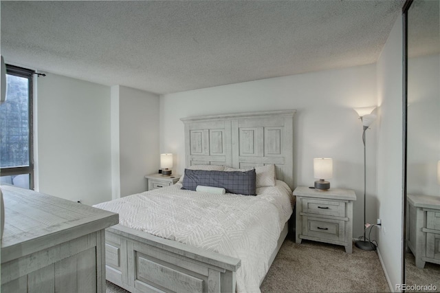 carpeted bedroom featuring a textured ceiling