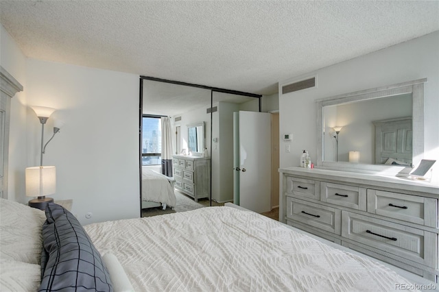 bedroom featuring a textured ceiling and a closet