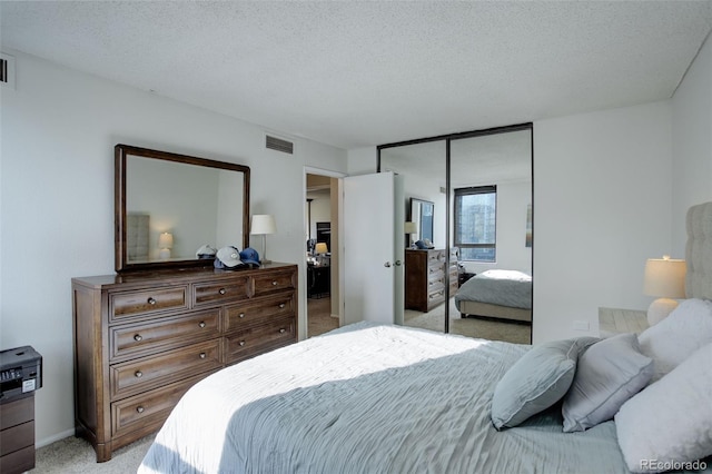 bedroom with light carpet, a closet, and a textured ceiling