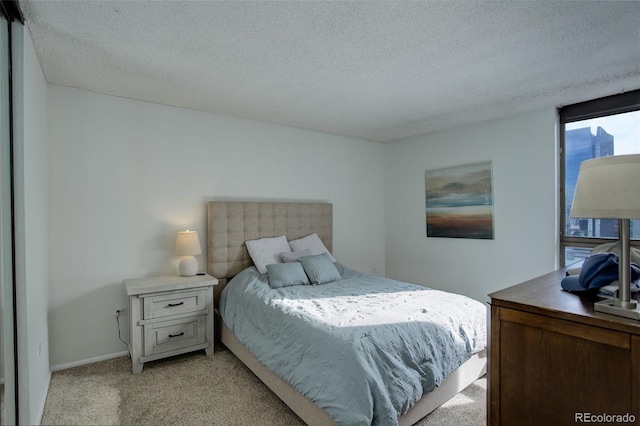 carpeted bedroom featuring a textured ceiling