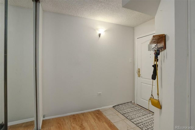 interior space with light tile patterned floors and a textured ceiling