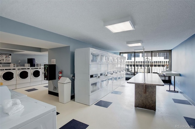 laundry area with a textured ceiling, washing machine and clothes dryer, and stacked washing maching and dryer