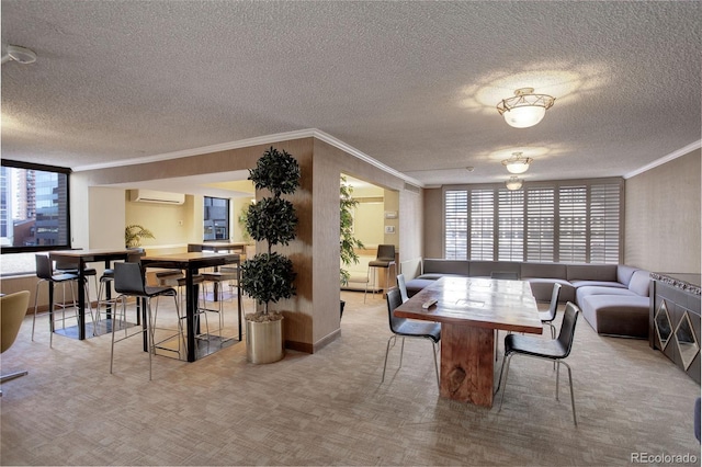 carpeted dining space with a wall mounted air conditioner, crown molding, and a textured ceiling