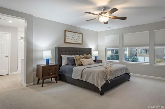 bedroom with ceiling fan and light carpet