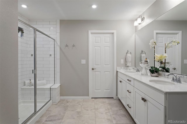 bathroom featuring an enclosed shower and vanity