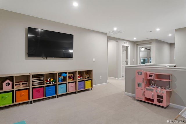 game room with ceiling fan and light carpet