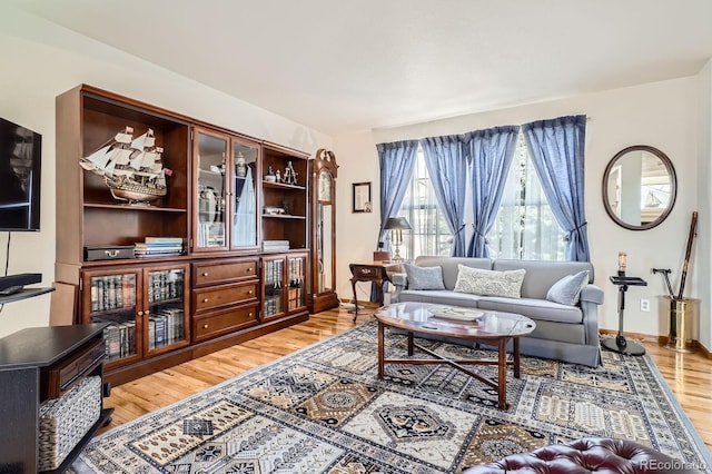 living room with light wood-style floors and baseboards