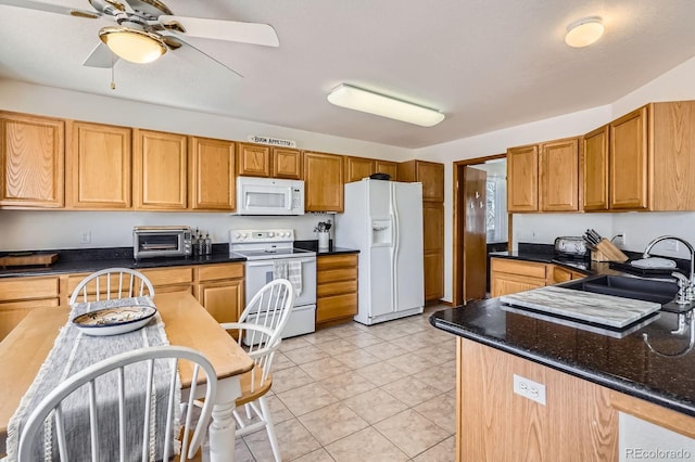 kitchen featuring light tile patterned floors, a sink, a ceiling fan, white appliances, and a toaster