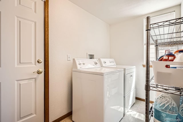 laundry room featuring baseboards, plenty of natural light, separate washer and dryer, and laundry area
