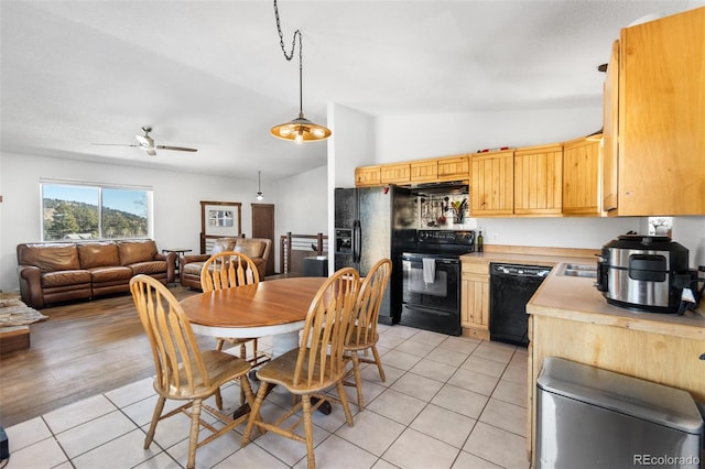 kitchen with ceiling fan, light hardwood / wood-style flooring, vaulted ceiling, decorative light fixtures, and black appliances