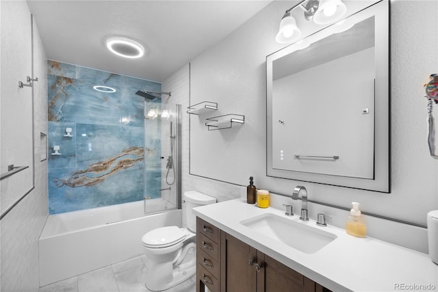 full bathroom featuring vanity, tiled shower / bath combo, and toilet