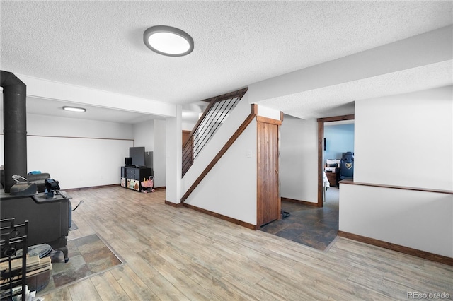 interior space featuring a textured ceiling and hardwood / wood-style flooring