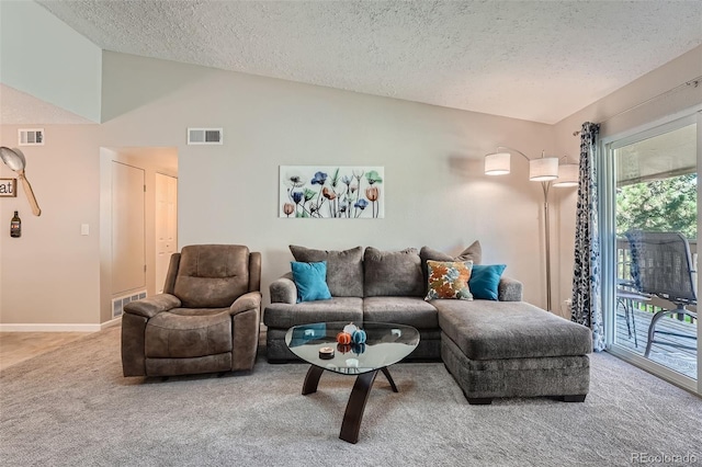 carpeted living area with visible vents, vaulted ceiling, and a textured ceiling