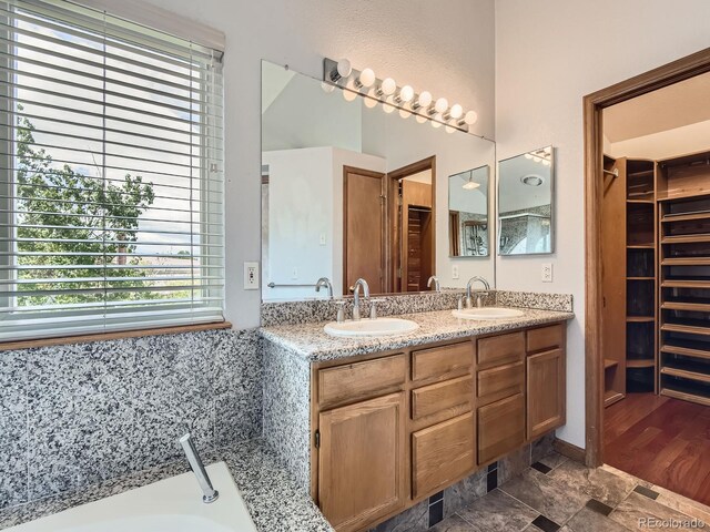 9412 La Quinta Way, Lone Tree, CO 80124 - full bath with a walk in closet, a garden tub, and double vanity