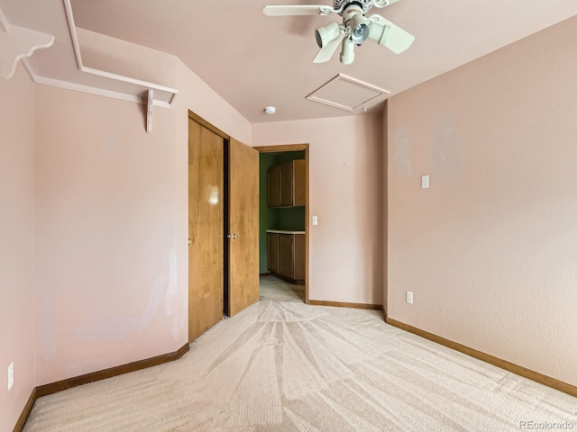9412 La Quinta Way, Lone Tree, CO 80124 - unfurnished bedroom featuring light carpet, baseboards, a ceiling fan, and attic access