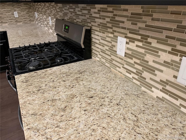 kitchen with dark hardwood / wood-style floors and gas stove