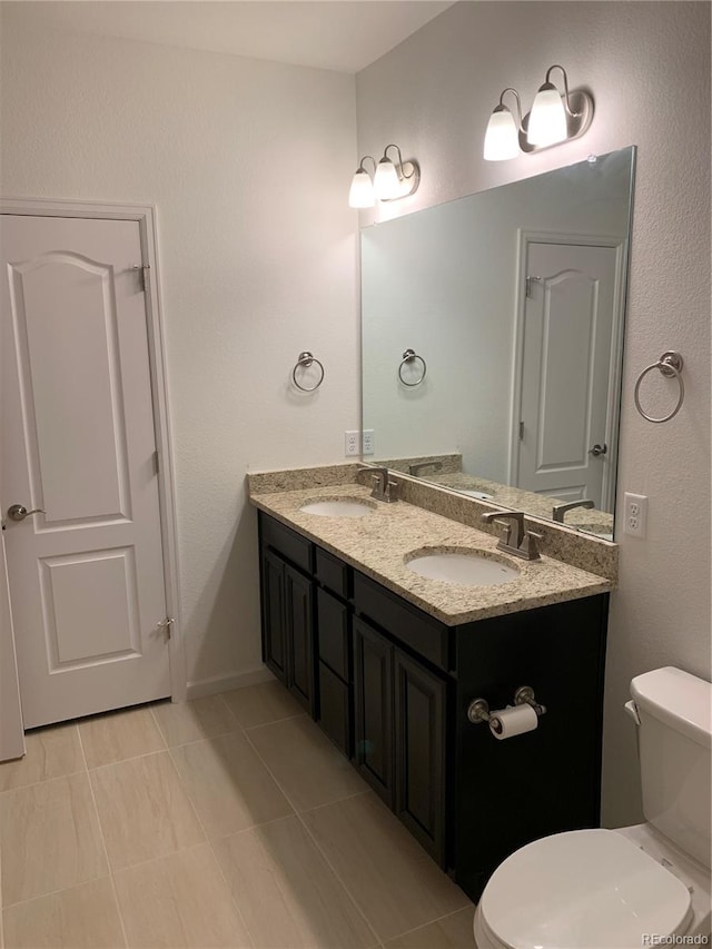 bathroom featuring tile patterned floors, toilet, and vanity