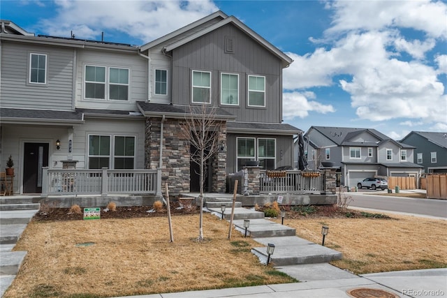 688 N Bersshine Ct, Watkins, CO 80137 - townhome / multi-family property featuring covered porch, a residential view, and stone siding