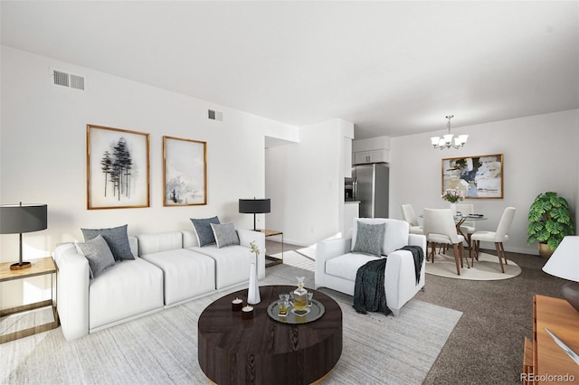 living room with light colored carpet and a chandelier