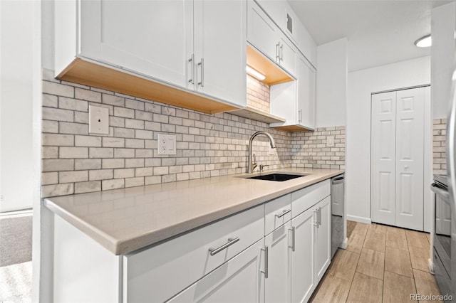 kitchen with sink, stainless steel appliances, and white cabinets