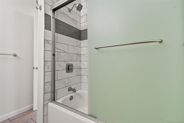 bathroom featuring shower / bath combination with glass door and hardwood / wood-style flooring