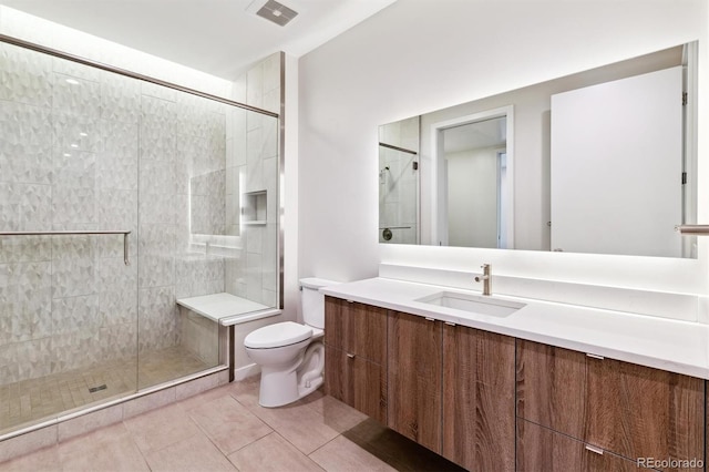 bathroom with an enclosed shower, tile patterned floors, vanity, and toilet