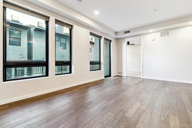 spare room with hardwood / wood-style flooring