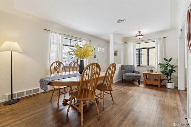 dining space featuring dark wood-type flooring