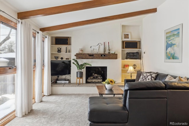 carpeted living room with lofted ceiling with beams