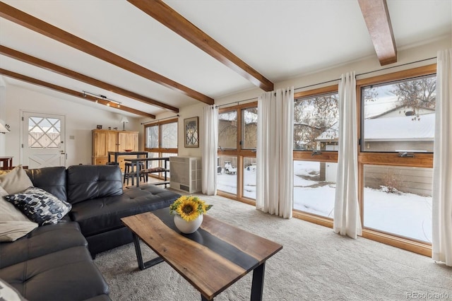 carpeted living room with vaulted ceiling with beams