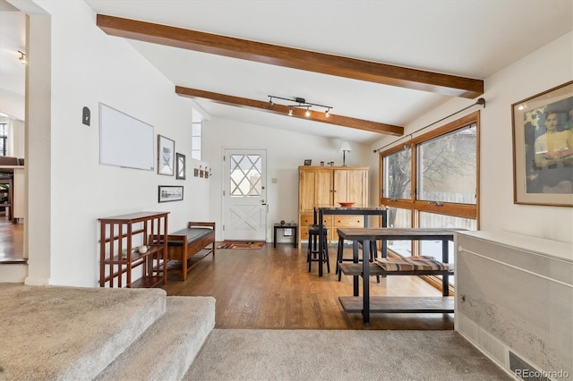 interior space featuring vaulted ceiling with beams and dark wood-type flooring