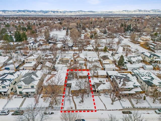 snowy aerial view with a mountain view