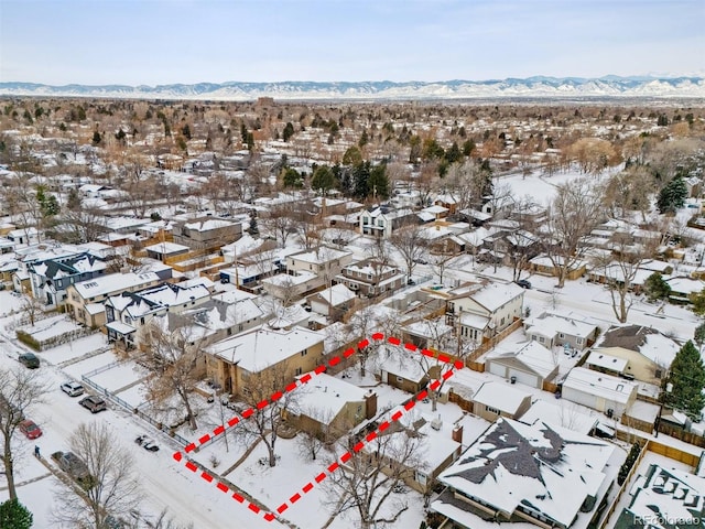 snowy aerial view featuring a mountain view