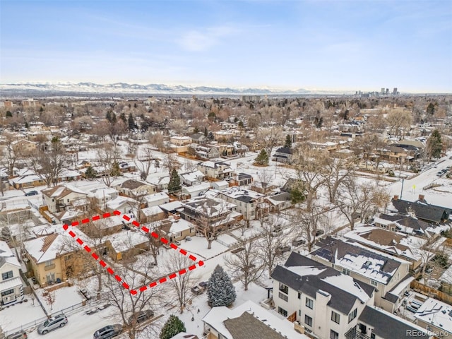 snowy aerial view featuring a mountain view