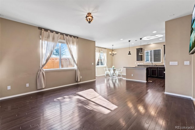 interior space with sink, a notable chandelier, and dark hardwood / wood-style flooring