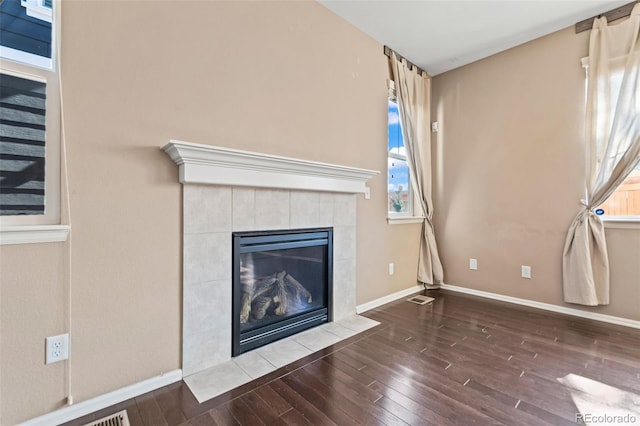 interior details featuring a fireplace and wood-type flooring