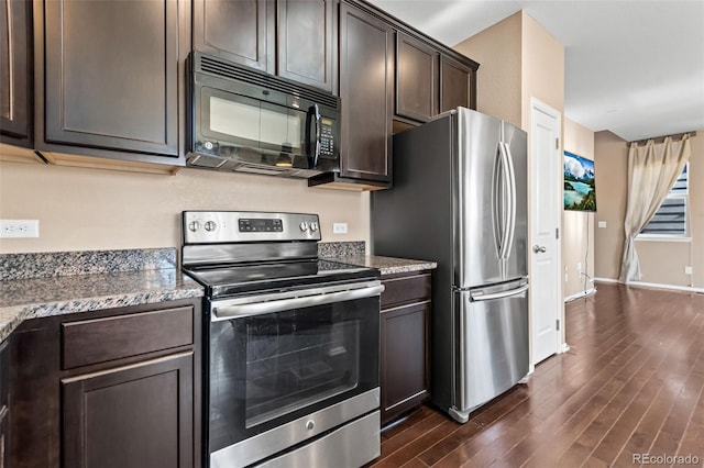 kitchen with stainless steel appliances, dark brown cabinets, stone countertops, and dark wood-type flooring