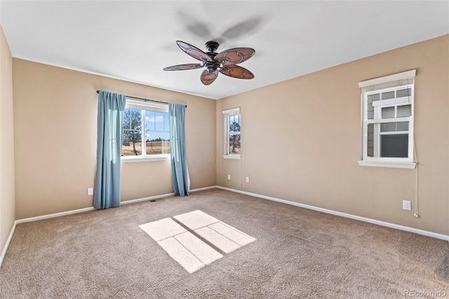 empty room featuring light carpet and ceiling fan