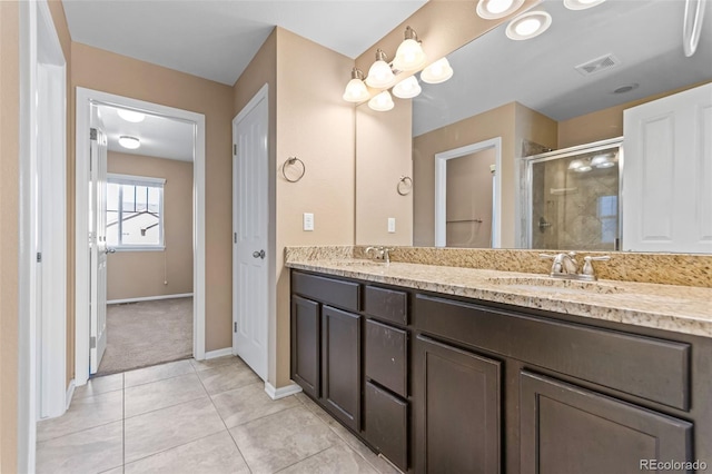 bathroom featuring vanity, an enclosed shower, and tile patterned floors