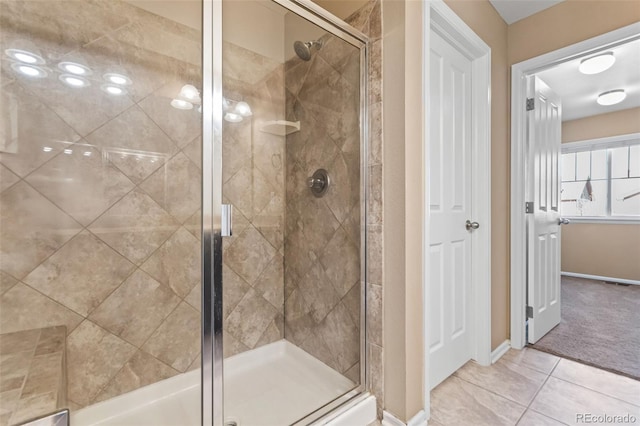 bathroom with tile patterned flooring and a shower with shower door