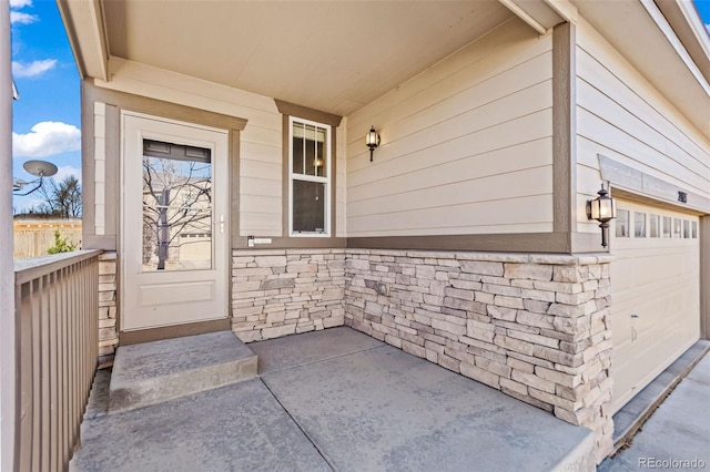 doorway to property with a garage