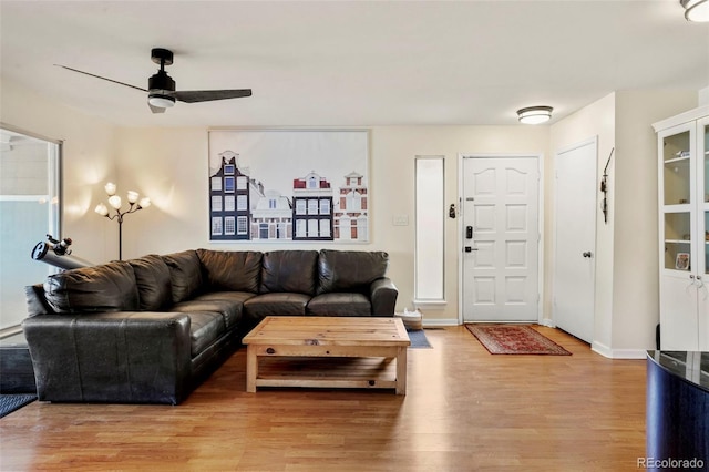 living room featuring ceiling fan and light hardwood / wood-style flooring