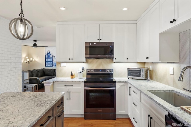 kitchen with a toaster, white cabinets, stainless steel appliances, and a sink