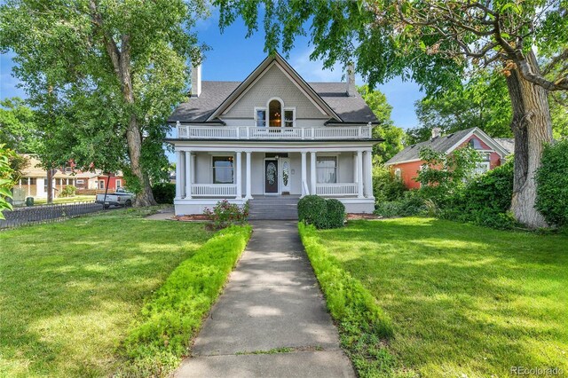7011 Grandview Ave, Arvada, CO 80002 - view of front of home with covered porch, a balcony, and a chimney