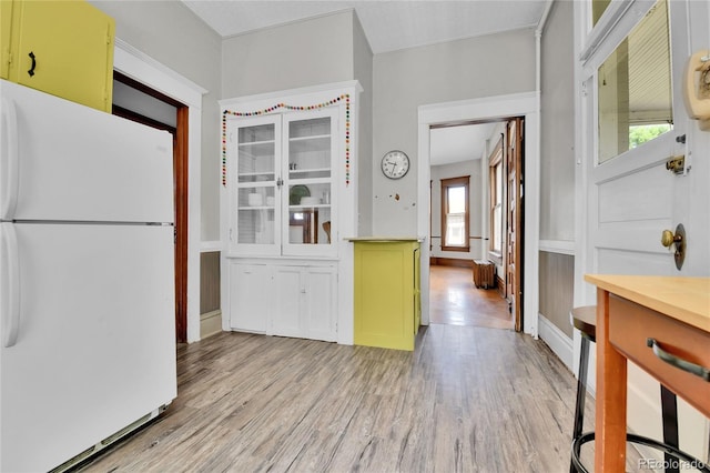 7011 Grandview Ave, Arvada, CO 80002 - kitchen with freestanding refrigerator, light wood-style floors, and green cabinetry