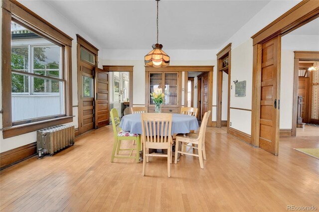 7011 Grandview Ave, Arvada, CO 80002 - dining space with radiator and light wood-style floors